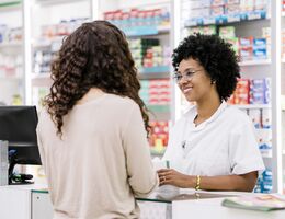 A woman talks to a pharmacist.